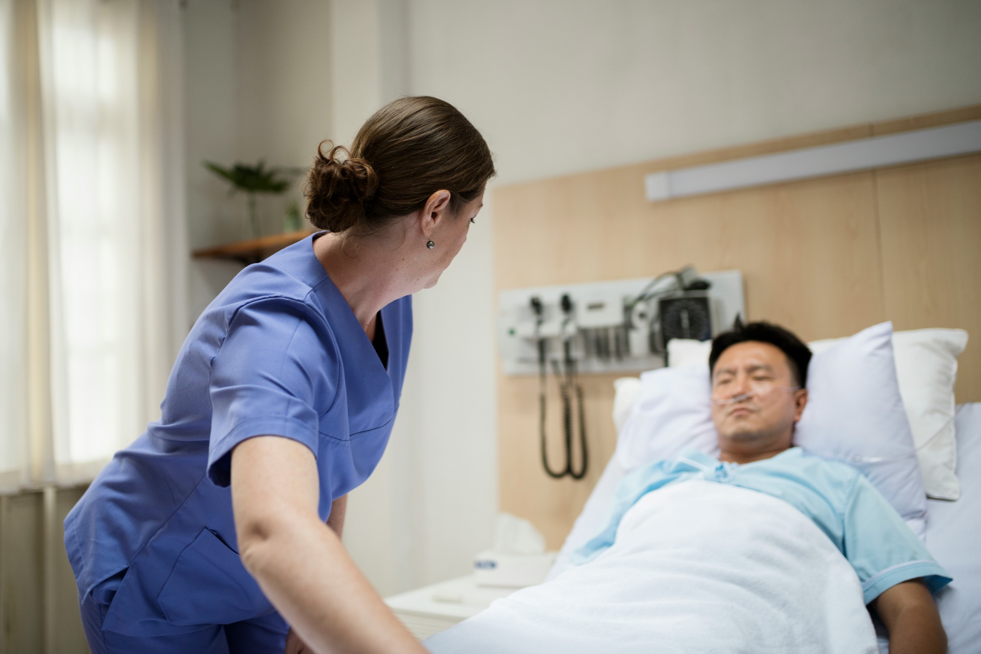 Nurse attending to a patient in an Australian hospital setting