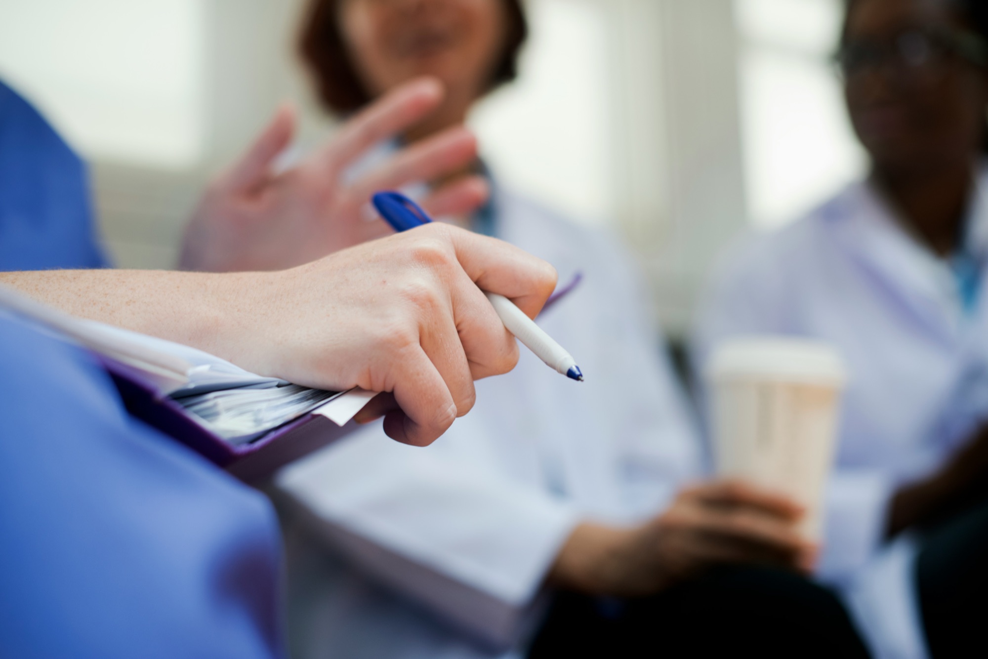 Healthcare team in discussion during a clinical handover or training session