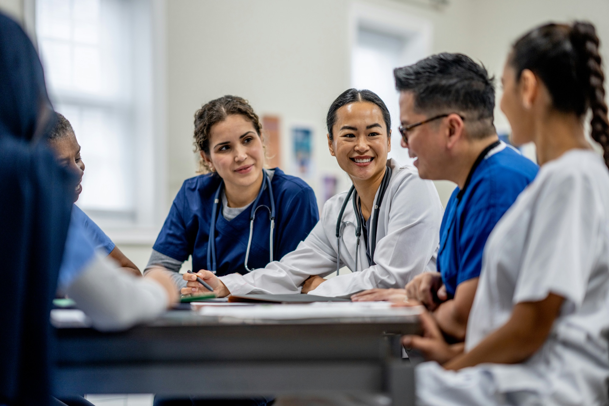 Healthcare professional in a reflective, collaborative setting